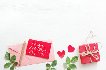 Romantic background with roses, heart symbols, gift box and red card with the text 