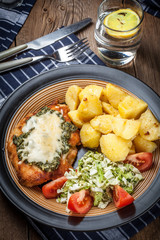 Fried chicken fillet with spinach and cheese.