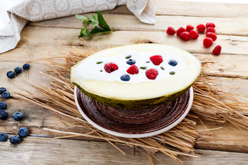 melon with yogurt, raspberries and blueberries