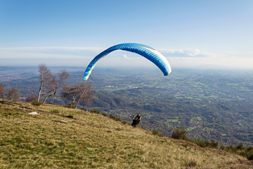 Paraglider takeoff on the mountains, italian Alps. Piedmont