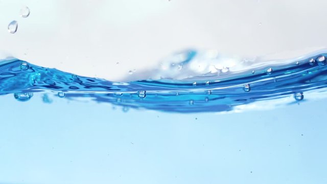 Blue water with bubbles slow motion.