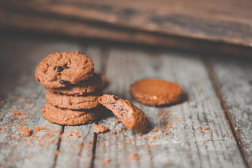 Chocolate cookies on wooden table. Chocolate chip cookies shot on coffee colored cloth, closeup, Brown tone concept 