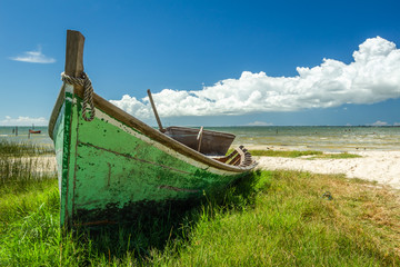 Landscape with old wooden boat belonging to local fishermen at Barranco beach, located in the city of São José do Norte, in southern Brazil.
