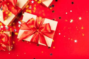 Several gift boxes with bows on a red background.