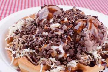 Waffles with ice cream, toping flavors and chantilly cream