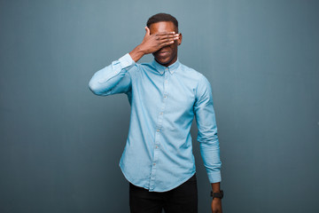 young african american black man covering eyes with one hand feeling scared or anxious, wondering...