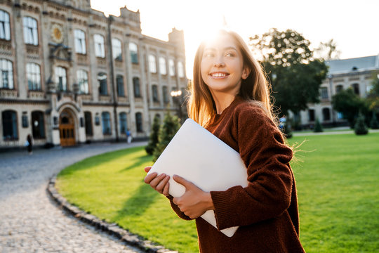 Happy Student Lifestyle, Candid Natural People Life Concept. Pretty Beautiful Girl Teenager Going To Her Class In University Campus With Laptop Computer In Hands, Modern Education Technologies.