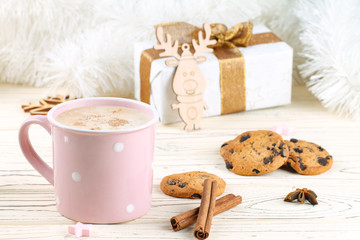 Cappuccino in a pink cup. Cookies with chocolate. The cozy home life. Wintertime.