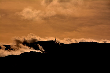 Silhouette of the Mont Ventoux surrounded by clouds. Provence. France.