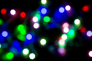 Christmas lights are lit on a black background. Copy the area for the top view text.