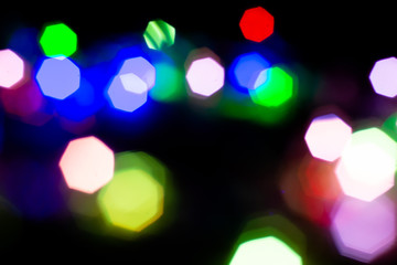 Christmas lights are lit on a black background. Copy the area for the top view text.