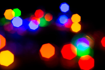 Christmas lights are lit on a black background. Copy the area for the top view text.