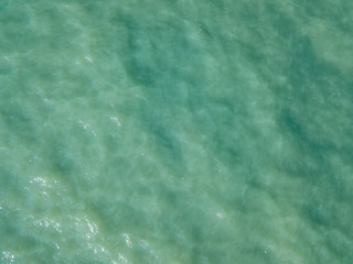 Aerial view of turquoise waves, water surface texture. Thailand