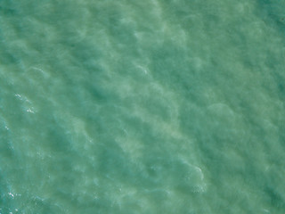 Aerial view of turquoise waves, water surface texture. Thailand