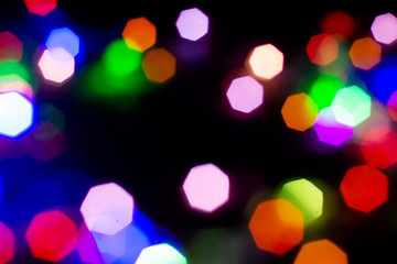 Christmas lights are lit on a black background. Copy the area for the top view text.