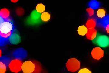 Christmas lights are lit on a black background. Copy the area for the top view text.