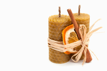 Christmas composition – wax candles, cinnamon and dried orange. isolated on white background. space for inscriptions.