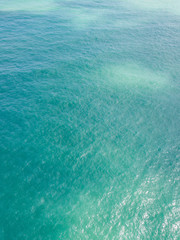 Aerial view of turquoise waves, water surface texture. Thailand