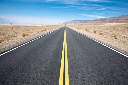 Empty scenic desert road in the Death Valley, USA.