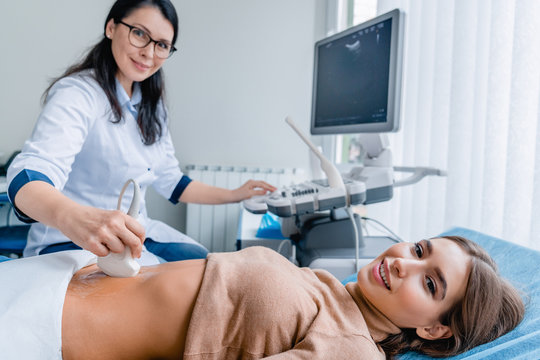 Portrait of woman getting ultrasound from doctor
