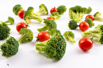 Healthy vegetable broccoli and tomatoes on white background
