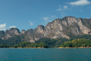Tropical Thai jungle lake Cheo lan, wild mountains nature national park ship yacht rocks