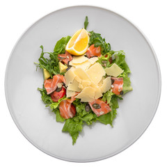 Salmon carpaccio salad, iceberg salad, arugula, parmesan, pumpkin seeds and olive oil. Gourmet...