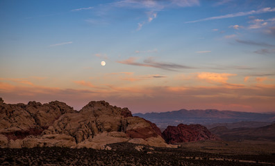 moon over Redrock mountains at sunset