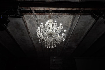 Image of luxury vintage electric chandelier in dark loft room