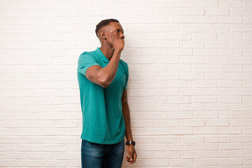 young african american black man with a concentrated look, wondering with a doubtful expression,...