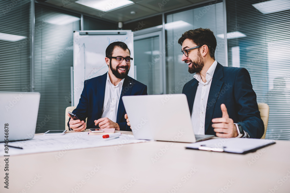 Poster two office workers in business meeting sitting at desk using computer for business training, profess
