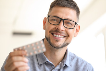 Man with pills at home