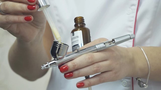 The process of preparing an oxygen facial treatment in beauty salon, close up 