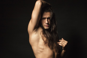 Naklejka premium Handsome sport masculed sexy stripped guy with white towel on isolated black background font