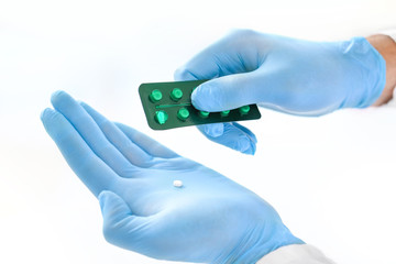 Doctor with pills in clinic, closeup