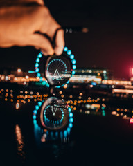 glasses on the background of the Ferris wheel at night bokeh
