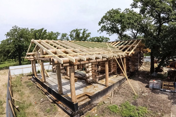 Stage of construction of a wooden house.