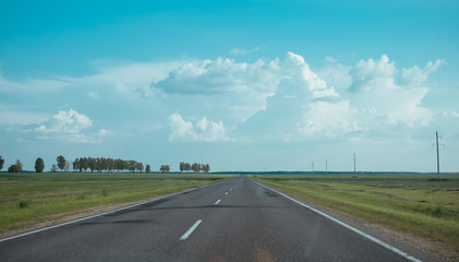Road trip view from the car to asphalt raod and blue sky