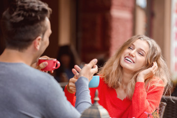 Happy young couple on romantic date in cafe