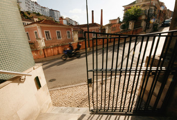 Coimbra Backstreet with Motorcyclist