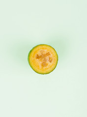 Fresh feijoa fruits with slices on a mint background. Fruit content