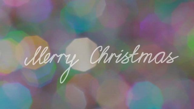 "Merry Christmas" Text agaist Glowing Bokeh Backround