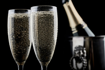 Two champagne glasses with bubbly drink and christmas decoration ball © AK Media