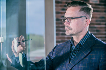  successful businessman in the office at the glass wall, mentor coach   training