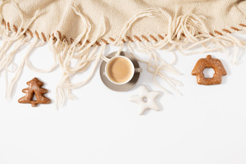 Fototapeta na wymiar Christmas sweet composition. Xmas gingerbread cookies, knitted woolen plaid and coffee on white background. Christmas, New Year, winter concept. Flat lay, top view, copy space