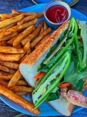 Crab sandwich with greens and fries