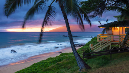Kamaole Beach Sunset Maui. Sunset glow on the west Maui mountains, swaying palm trees in the...