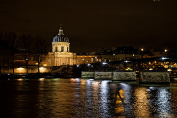 Naklejka premium Paris, France - November 17, 2019: The Pont des Arts or Passerelle des Arts is a pedestrian bridge in Paris which crosses the Institut de France. With Institut de France in background