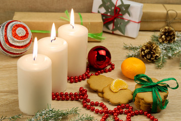 three burning candles with Christmas decoration. xmas composition.