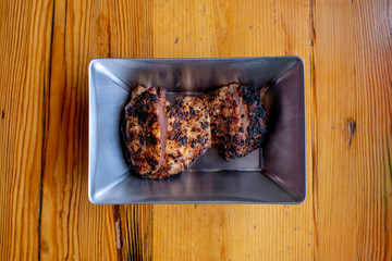 Grilled Chicken Dish with green onions, top view vertical shot